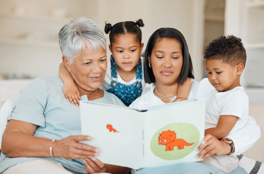 Shot of a family reading a story book together at home.